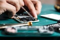 Electronics repair service. Technician disassembling smartphone for inspecting