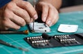 Electronics repair service. Technician disassembling smartphone for inspecting.