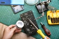 Electronics repair service, Technician fixing electronic circuit board with soldering iron and tin
