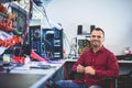 Electronics service shop owner at work repairing computer Royalty Free Stock Photo