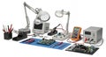 Electronics Workstation Overview with Soldering Iron, Multimeter and Circuit Boards in Repair or Development Setup on Royalty Free Stock Photo