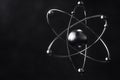 Electrons orbiting around nucleus depicting atomic model on dark background Royalty Free Stock Photo