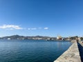 Elefsina Attica Greece. Moored ship at port in sea opposite Petroleum Oil Refinery industrial area