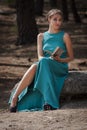 Elegance blonde girl in blue evening dress