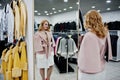 Elegance blonde girl in fur coat store