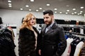 Elegance blonde girl in fur coat and stylish turkish man at the store of fur coats and leather jackets Royalty Free Stock Photo