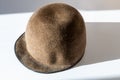 Elegance brown felt hat. The stylish hat is on the the white surface with hard shadow Royalty Free Stock Photo