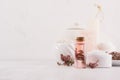 Elegance light soft white homemade cosmetics set of products for body care and bath accessories with pink flowers on white wood. Royalty Free Stock Photo