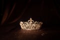 Elegance luxury royal crown on satin, silk background. Vintage
