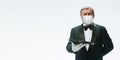 Elegance senior man waiter in protective face mask on white background. Flyer with copyspace.