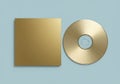 Elegance in simplicity: Golden compact disc and square case against subtle backdrop Royalty Free Stock Photo