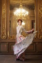 Elegance woman with flying dress in palace room Royalty Free Stock Photo