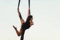 Elegance young beautiful woman dance with aerial silk on a sky background. Fly yoga sport Royalty Free Stock Photo