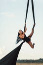 Elegance young beautiful woman dance with aerial silk on a sky background. Fly yoga sport Royalty Free Stock Photo