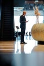 Elegant african american businessman using smartphone in lobby of business center Royalty Free Stock Photo