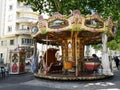 Antique carousel running in a French square