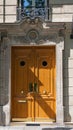 Elegant antique double door entrance of baroque building in Paris France. Vintage wooden doorway and whimsical fretwork wall. Royalty Free Stock Photo