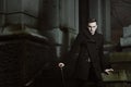 Elegant aristocratic vampire in a stone cemetery Royalty Free Stock Photo