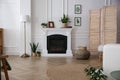 Elegant artificial fireplace in room. Interior design Royalty Free Stock Photo
