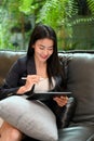 Elegant Asian businesswoman using a portable tablet touchpad Royalty Free Stock Photo