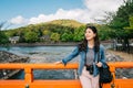 An elegant asian traveler relying on the handrail Royalty Free Stock Photo