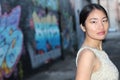 Elegant Asian woman in dark urban alley way isolated with copy space Royalty Free Stock Photo
