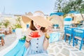 Elegant asian woman in hat drinking coffee from elegant cup in restaurant Royalty Free Stock Photo