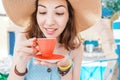 Elegant asian woman in hat drinking coffee from elegant cup in restaurant Royalty Free Stock Photo
