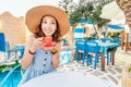 Elegant asian woman in hat drinking coffee from elegant cup in restaurant Royalty Free Stock Photo