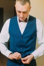 Elegant athletic young man dressing blue tuxedo suit for festive event Royalty Free Stock Photo