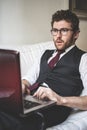 Elegant attractive fashion hipster man using notebook Royalty Free Stock Photo