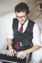 Elegant attractive fashion hipster man using notebook Royalty Free Stock Photo