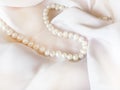 Pearl necklace on a beautiful luxury cream silk background
