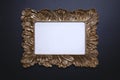 Elegant background, template for text, logo or picture. Golden decorative picture frame on the black background. Free space, copy