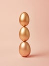 Elegant balance of three golden Easter eggs against a soft background Royalty Free Stock Photo