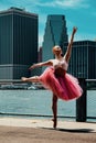 elegant ballerina in dress dancing with cityscape on background Downtown Brooklyn, New York city financial district