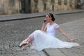 Elegant ballerina drinking coffee on the street