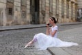 Elegant ballerina drinking coffee on the street