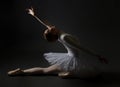 Elegant ballerina made a deflection. photo shoots in the studio on a dark background Royalty Free Stock Photo