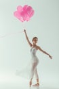 elegant ballerina with pink balloons