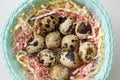 In an elegant basket in multi-colored tinsel are quail eggs. Easter concept