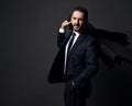 Elegant bearded businessman, boss in stylish modern office suit walking holding his coat on shoulder Royalty Free Stock Photo