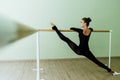 Elegant beautiful ballerina with a perfect body doing stretching exercise.