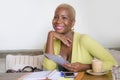 Elegant and beautiful black Afro American business woman working online with digital tablet pad at coffee shop drinking coffee in Royalty Free Stock Photo