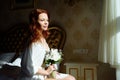 Beautiful redhair lady in elegant white panties and peignoir. Fashion portrait of model indoors. Beauty woman with lace linge Royalty Free Stock Photo