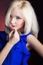 Elegant beautiful girl blonde with red lips in a blue dress in the Studio Royalty Free Stock Photo