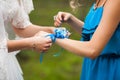 Elegant beautiful stylish bride helps bridesmaid in blue dress