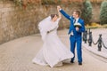 Elegant beautiful wedding couple, strolling in park near sandstone wall Royalty Free Stock Photo