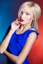 Elegant beautiful women blonde with red lips in a blue dress in the Studio Royalty Free Stock Photo