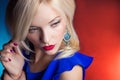 Elegant beautiful women blonde with red lips in a blue dress in the Studio Royalty Free Stock Photo